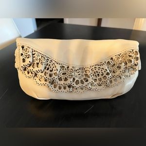 Ivory leather clutch, with eyelet trim, from Henri Bendel